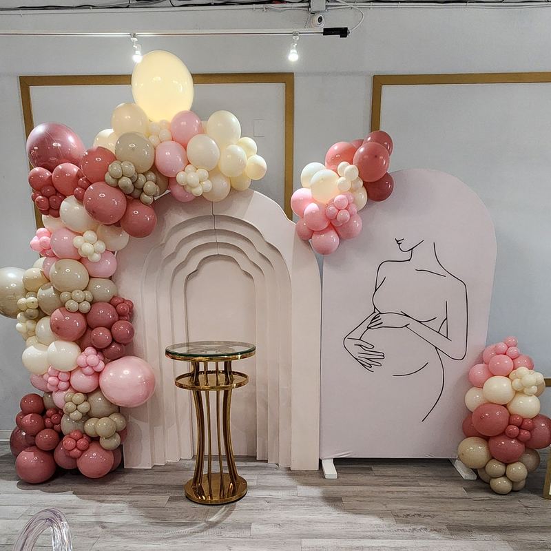 Baby shower backdrop with a mom-to-be silhouette, blush balloon garland and BABY blocks