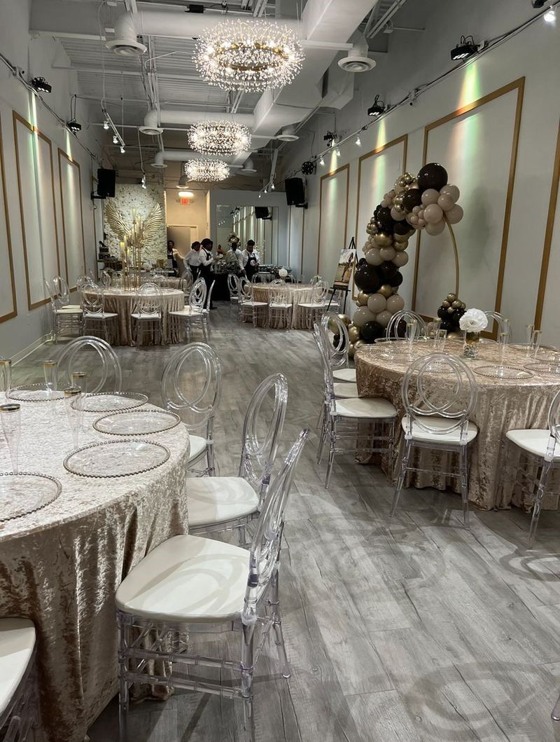 Tables with gold sequin linens across the room