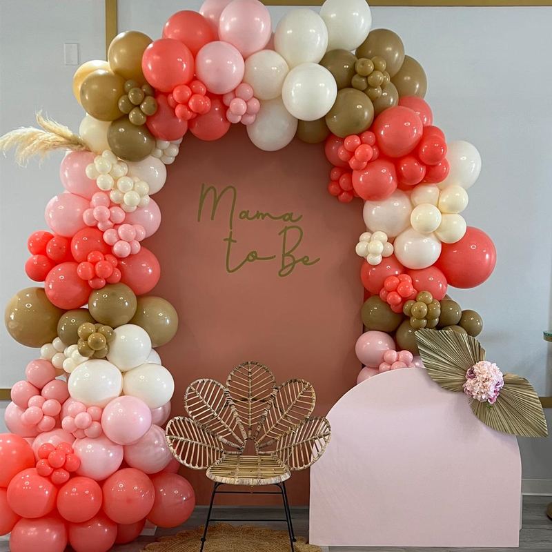 Mama to Be boho arch with coral, pink, olive and cream balloons and dried palm leaves